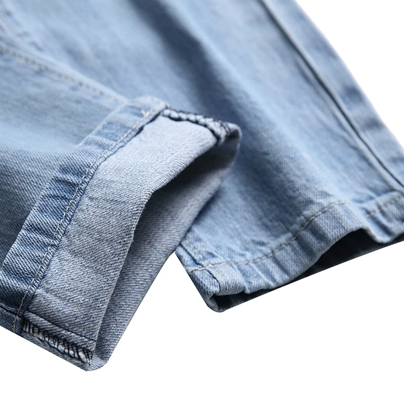 Nye mænd bære revet hul denim jeans lang ødelægge hul lige patch lys blå vasket bukser og store bukser